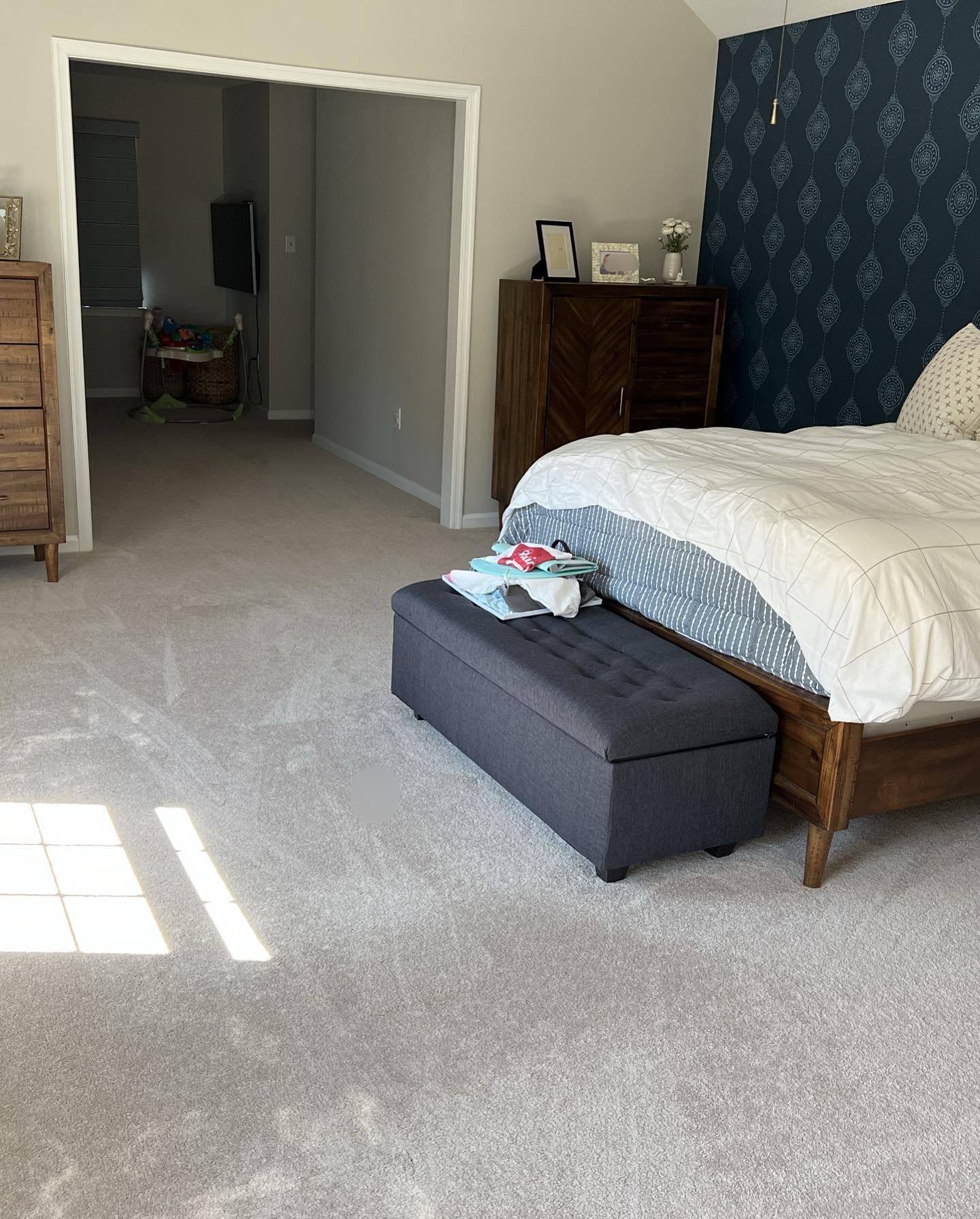Master bedroom with navy accent wall, freshly cleaned