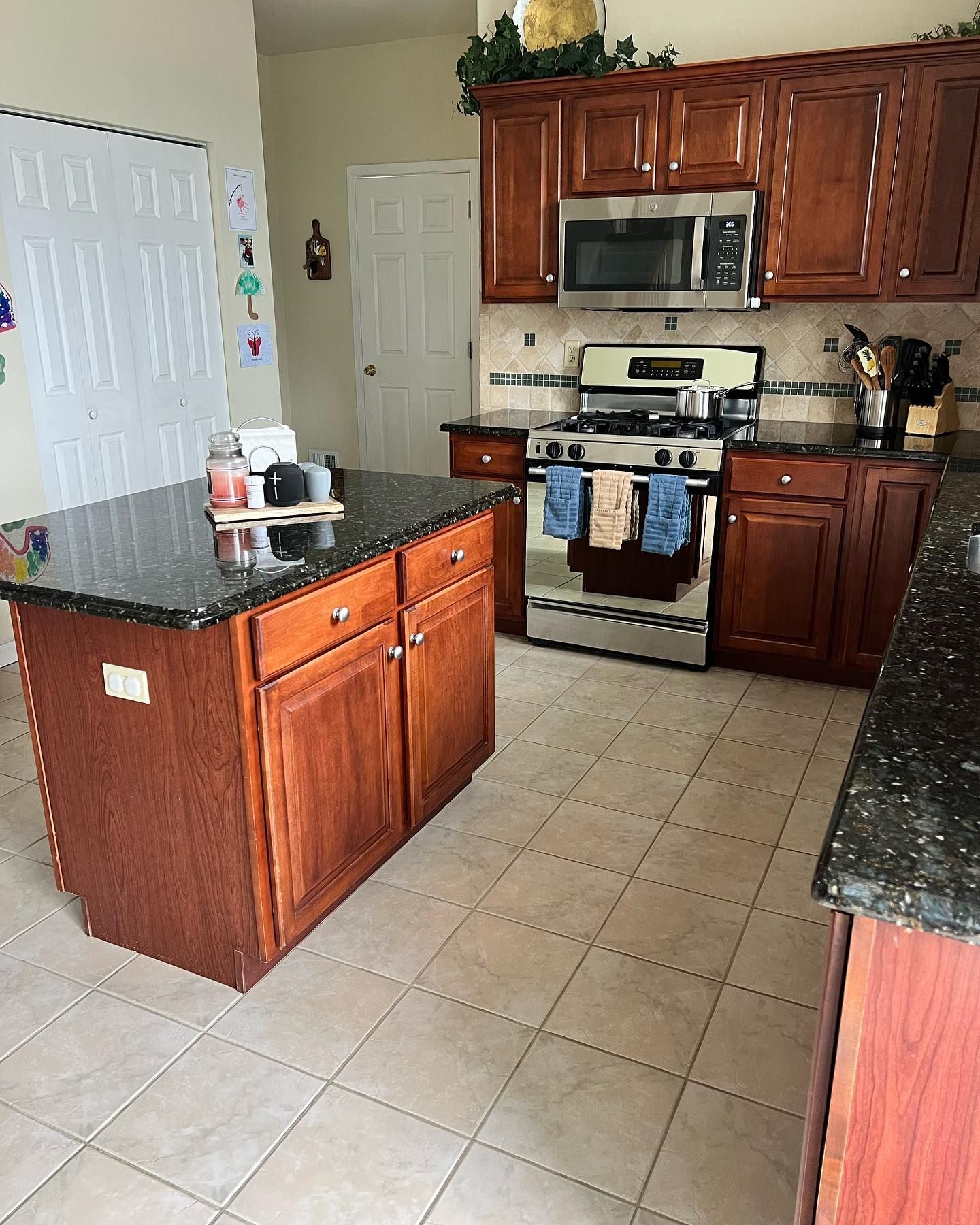 Cherry-cabinet kitchen with island after a detailed clean