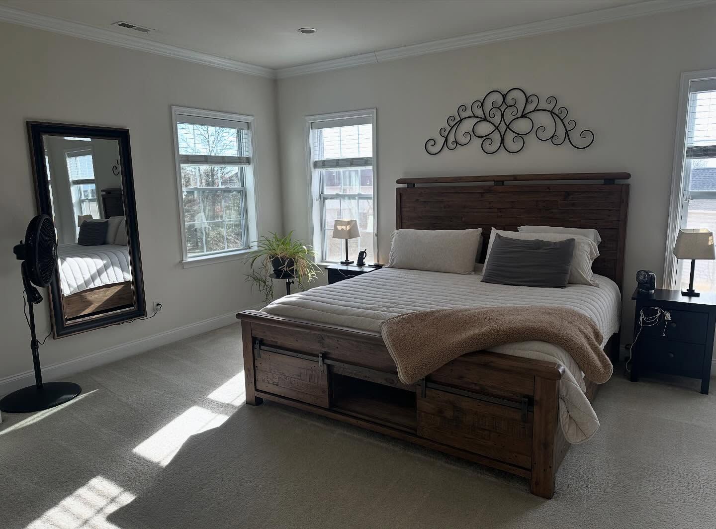 Tidied master bedroom with made bed
