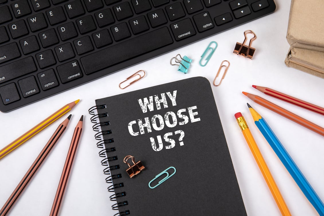 WHY CHOOSE US. Black notebook and computer keyboard